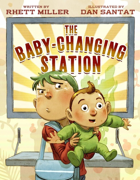 Little boy with diaper bag holding his baby brother in front of a baby-changing station